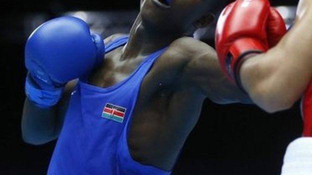 Benson Gicharu Njangiru (L) of Kenya and Tafari Ebanks of the Cayman Islands box during their men's bantamweight quarter-final bout at the 2014 Commonwealth Games in Glasgow, Scotland, 30 July 2014