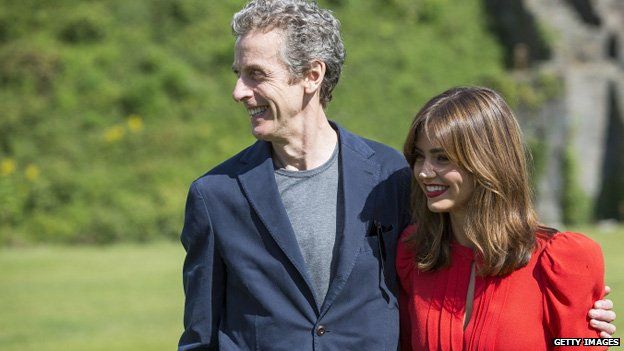 Peter Capaldi and Jenna Coleman pose for photographers at Cardiff Castle before attending the Cardiff premiere of Doctor Who at Cardiff's St David's Hall