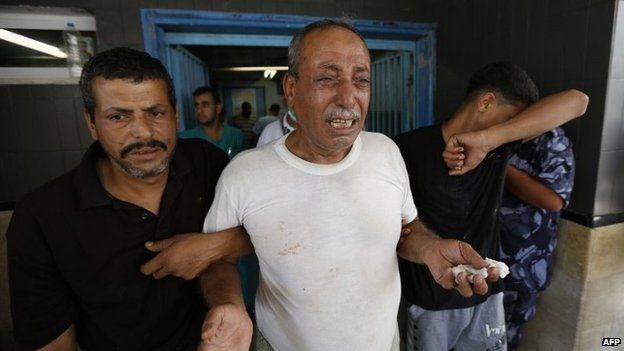 Palestinian man mourns after his son is killed in an Israeli air strike in Gaza City on 8 August 2014