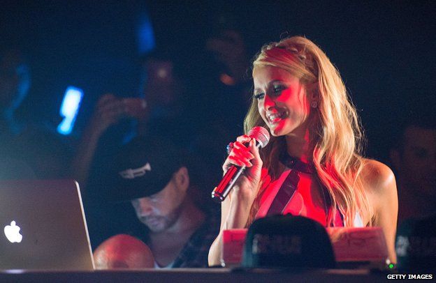 Paris Hilton holding microphone