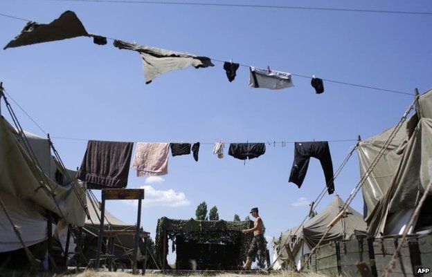 A serviceman walks in the camp of the Ukrainian troops in Donetsk region on August 9