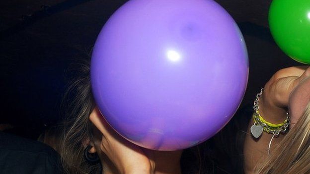 A women with a laughing gas balloon