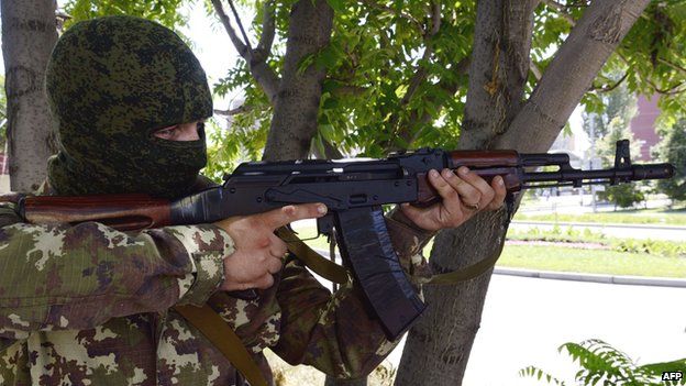 Pro-Russian rebel using Kalashnikov in Donetsk - file pic