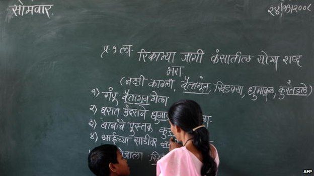 Hindi script on a blackboard in a classroom in India