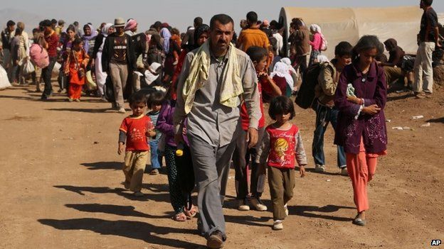 Displaced Iraqis from the Yazidi community cross the Syrian border