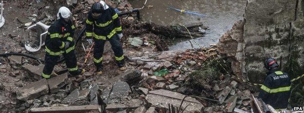 Emergency service workers at the site where the airplane crashed in Santos, Sao Paulo state, Brazil, 13 August 2014.