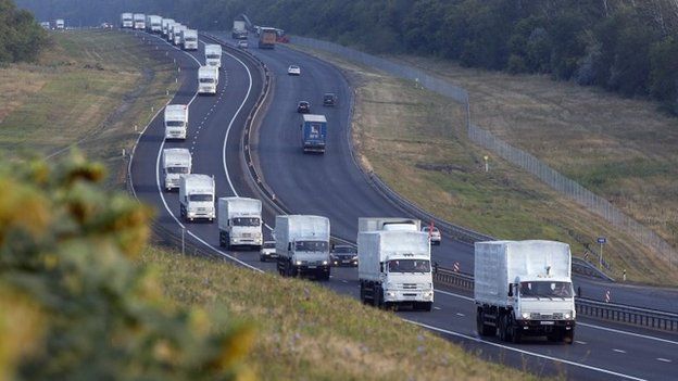 A convoy of white trucks with humanitarian aid moves from Voronezh towards Rostov-on-Don, Russia, early Thursday, Aug. 14
