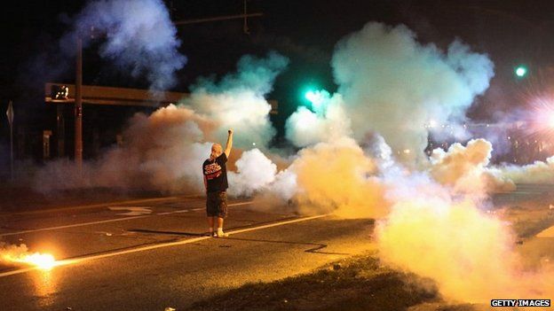 A demonstrator stands his ground amid tear gas fired by police during protests in Ferguson, Missouri - 13 August 2014