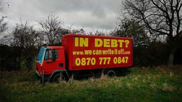 A old advertises the services of a loan company promising to write off personal financial debts next to the main M1 motorway in 2007