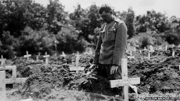 A soldier paying his respects to a fallen comrade in Belgrade.
