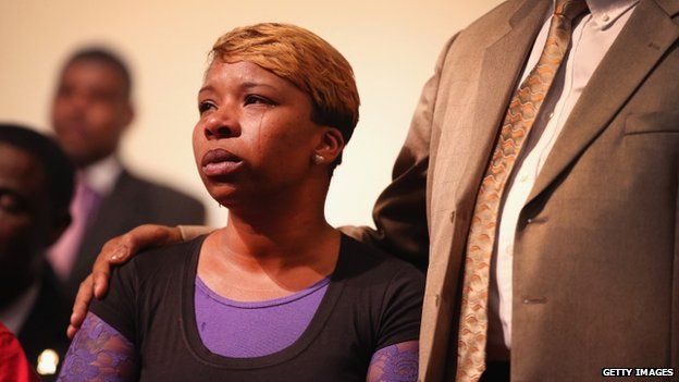 A tear rolls down the cheek of Lesley McSpadden, the mother of slain teenager Michael Brown, during a community meeting held at Greater St. Marks Family Church to discuss the killing of her son and the civil unrest resulting from his death 12 August 2014 in St Louis, Missouri