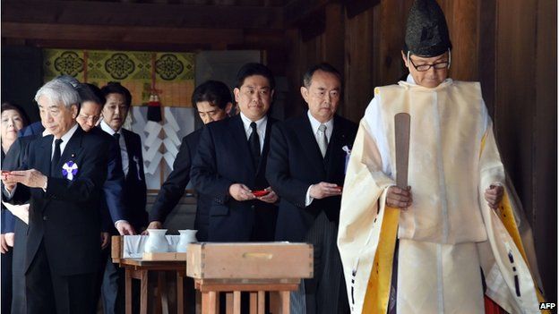 Japanese lawmakers follow a Shinto priest during a visit to the controversial Yasukuni shrine on 15 August 2014 to honour the country's war dead on the 69th anniversary of Japan's surrender in World War II, in Tokyo.