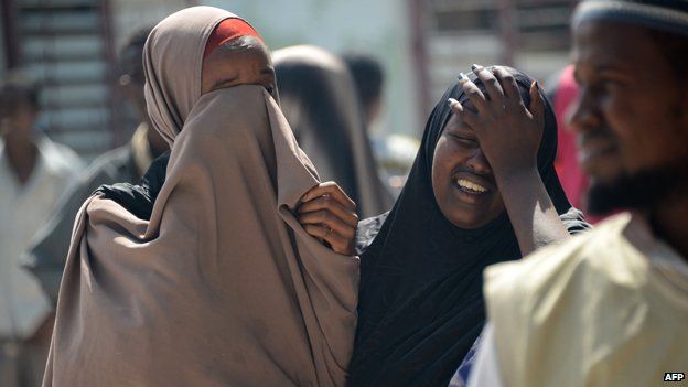 Two women mourn the death of a relative killed in an al-Shabab bomb attack earlier this month