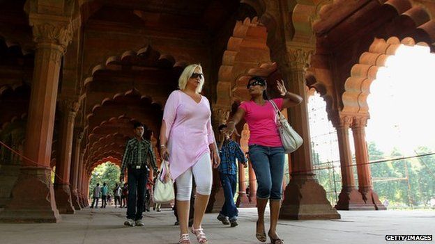 Women tourists walk through the Red Fort, Delhi