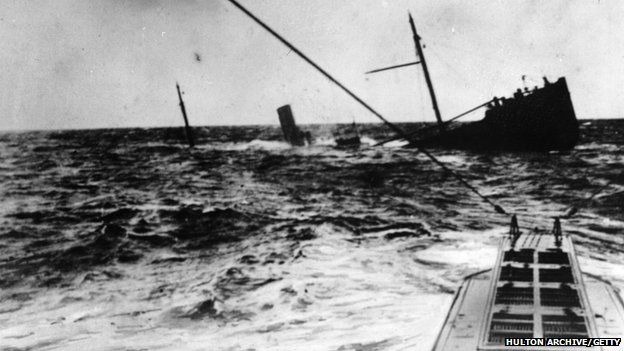 A British merchant vessel in the North Sea, sunk by a U-Boat which has surfaced, circa 1916.