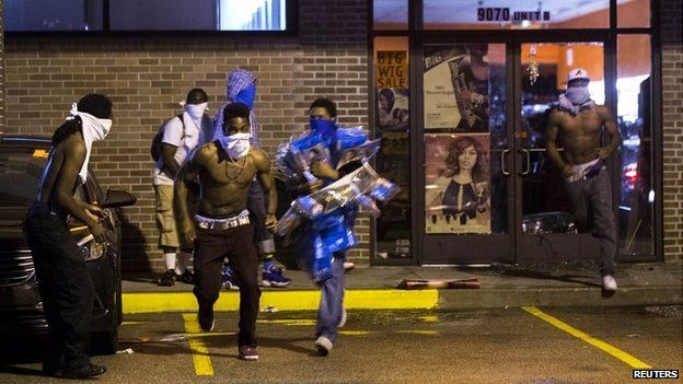 Looters run from a store in Ferguson, Missouri - 15 August 2014