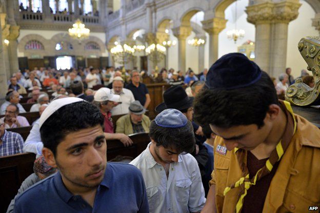 Men wearing skullcaps attend a praying ceremony, on July 31, 2014 inside Lyon's synagogue, in south-eastern France