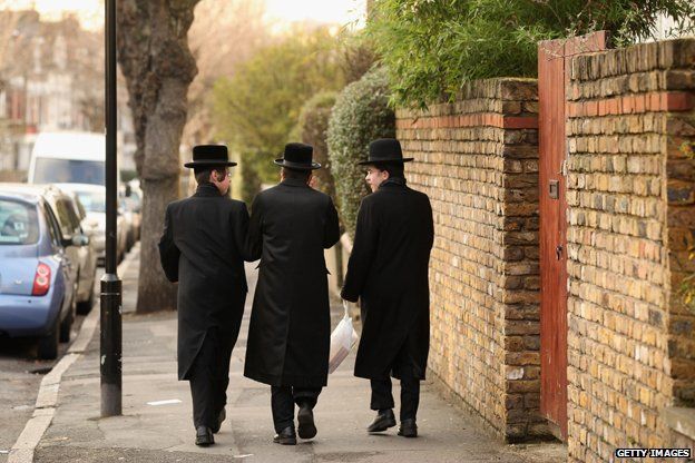 Jewish men walk along the street in the Stamford Hill area of north London on January 19, 2011 in London, England
