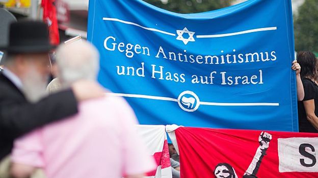 Pro Israel activists hold a banner reading 'Against Anti-Semitism and hate of Israel' at a demonstration as part of Quds Day in Berlin, Germany, 25 July 2014