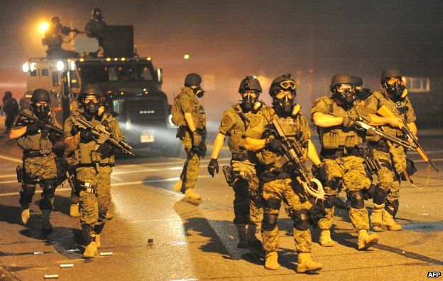 Police in riot gear patrol the streets in Ferguson, Missouri - 18 August 2014