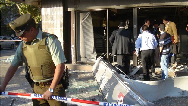 Police cordon off a bank in Santiago where a home-made explosive device went off
