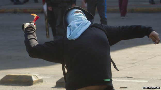 A masked protester in clashes with police in Santiago on 3 July, 2014