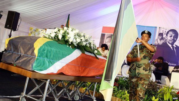A member of the Umkhnto We Sizwe Military Veterans Association forms a guard of honour around the coffin containing the remains of anti-apartheid and former Drum magazine journalist Nat Nakasa in a marquee at the King Shaka International airport on 19 August 2014 - Durban, South Africa
