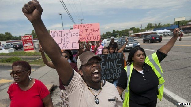 Protestors march down West Florissant Avenue in Ferguson, Missouri