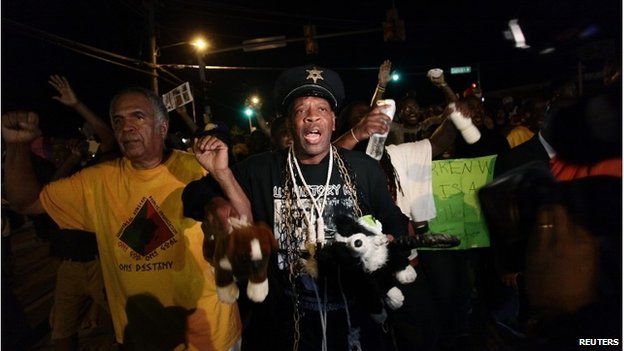 Demonstrators protest the shooting death of Michael Brown, in Ferguson, Missouri August 19