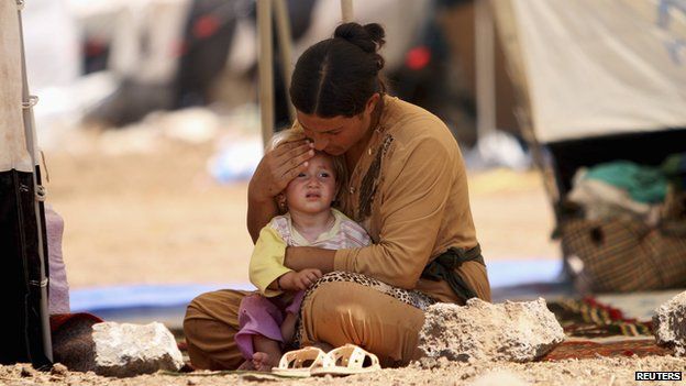 A Yazidi refugee and her child in Syria on August 17