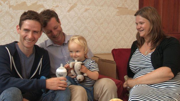 Michael Scott Kline and Nick Scott with surrogate mother Sarah Jones and child Elliot