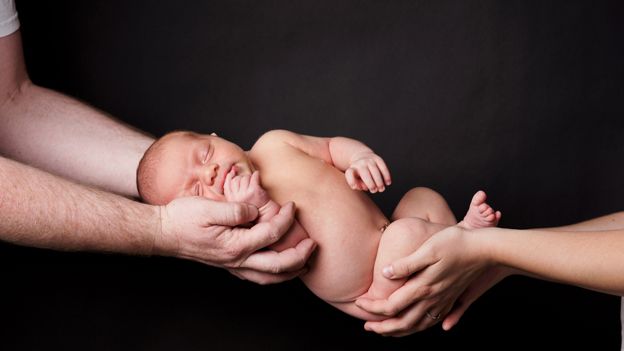 Baby being handed over