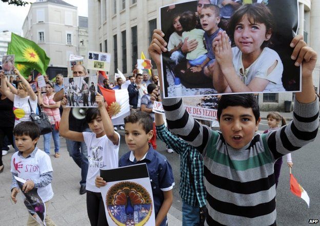Yazidi children in Angers in western France hold placards in support of their community in Iraq (20 August 2014)