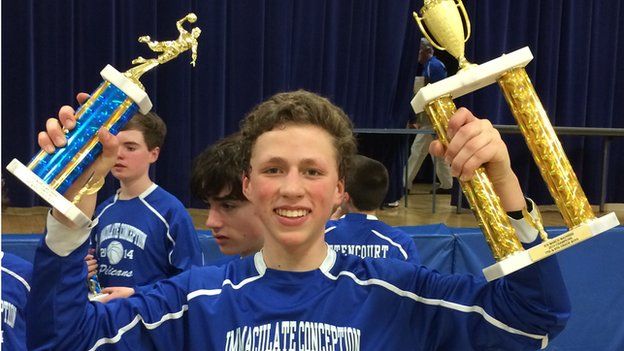 Christopher Herndon, a diabetic teenage boy, with basketball trophies in hand