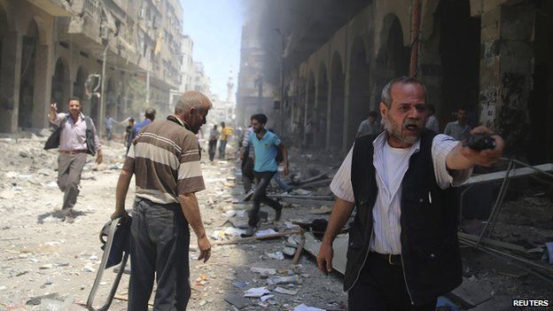 A man reacts in a damaged street due to what activists claimed was a car bomb explosion in a market in central Duma in the eastern al-Ghouta, near Damascus June 15, 2014