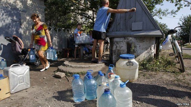 People take water from a well in the town of Avdiivka, Donetsk region - 22 August 2014