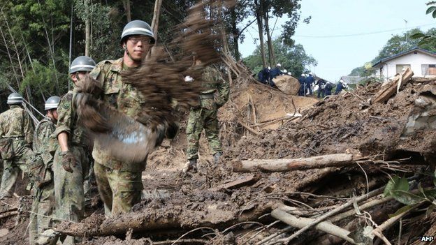 Defence personnel search for victims in mud three days after a landslide hit a residential area in Hiroshima (23 August 2014)