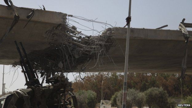 Damage to a bridge linking Tripoli and the western Libyan cities following clashes between rival militias west of Tripoli
