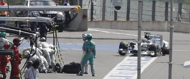 Hamilton enters the pits with his rear left tyre shredded
