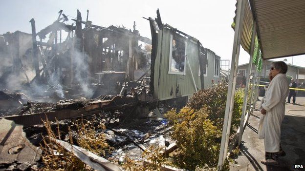 A Napa Valley resident surveys her home, destroyed by fire after the earthquake
