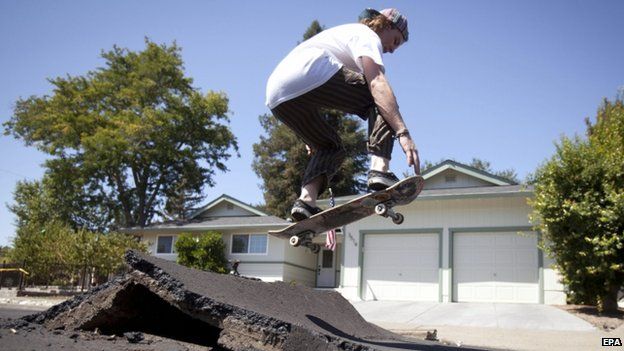A skater took advantage of a buckled street after a 6.1 magnitude earthquake hit Napa (24 August 2014)