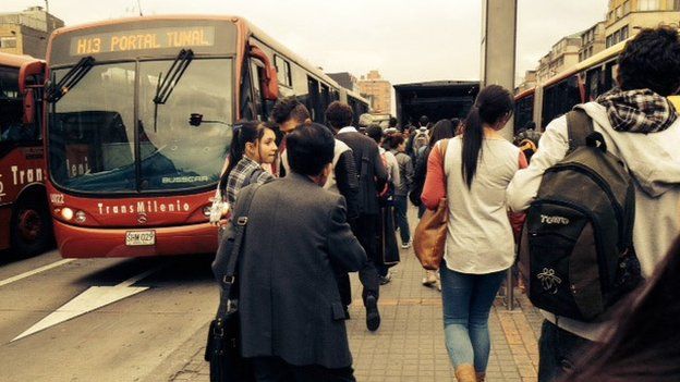 Passengers wait for a Transmilenio bus in Bogota