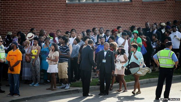 Guests wait in line to enter the Friendly Temple Missionary Baptist Church in St Louis