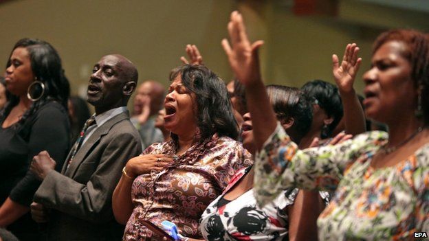 Mourners sing inside the Friendly Temple Missionary Baptist Church, St Louis,