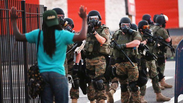 Police confront a civilian in Ferguson, Missouri