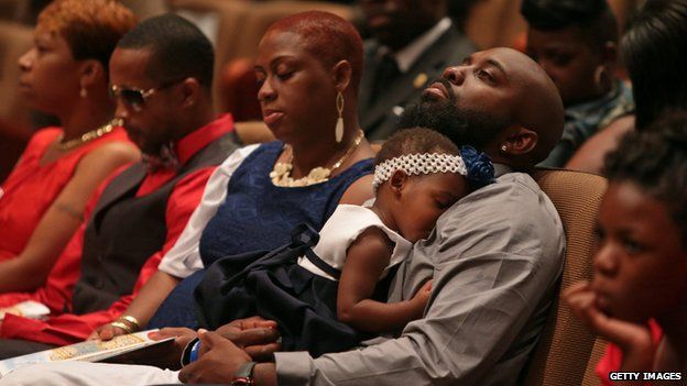 Michael Brown's mother Lesley McSpadden (far left) sits near Michael Brown Snr (right) at their son's funeral