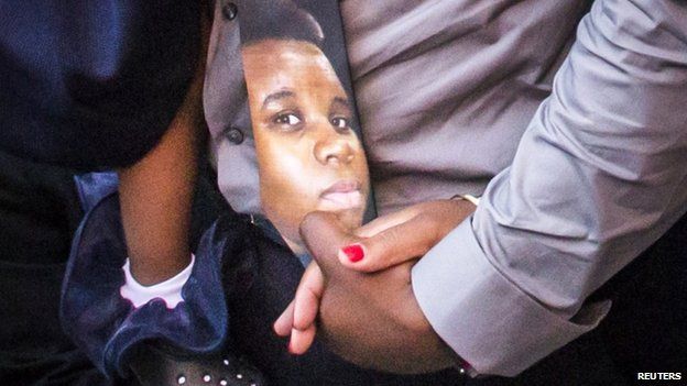 Michael Brown is seen on a tie worn by his father during the funeral
