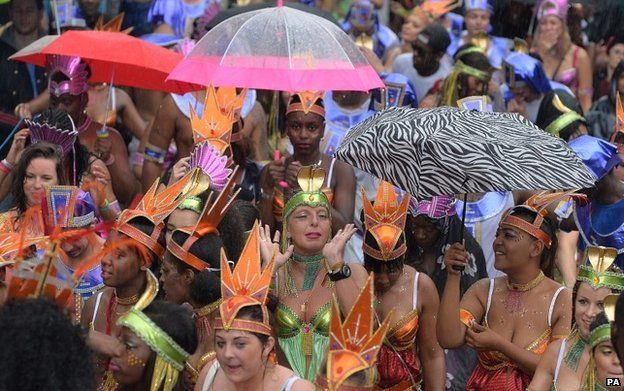 Revellers in the rain at the Notting Hill Carnival
