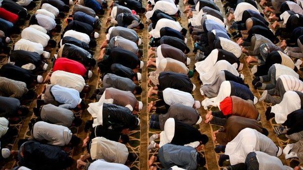 Men kneeling in prayer at a mosque
