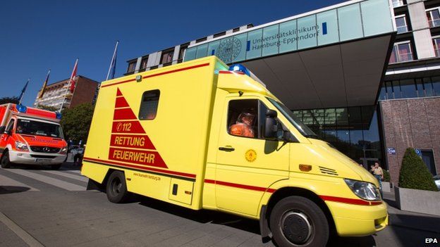 A convoy of rescue vehicles passes the main entrance of the University Hospital Hamburg-Eppendorf in Hamburg, Germany, 27 August 2014